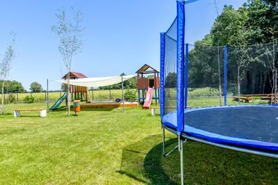 a park with a playground with a trampoline at KempingZator in Zator