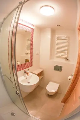 a bathroom with a sink and a toilet and a mirror at Main Square Platan Loft Collection in Kraków