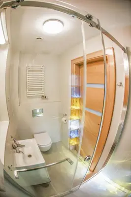 a bathroom with a sink and a toilet and a mirror at Main Square Platan Loft Collection in Kraków