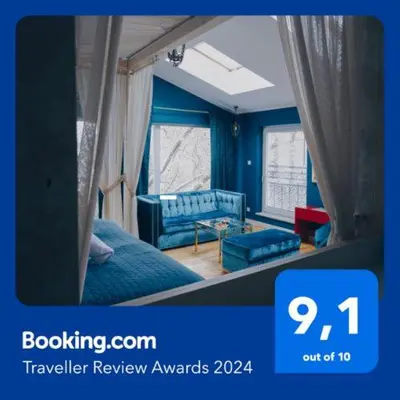 a blue bedroom with a bed and a window at Main Square Platan Loft Collection in Kraków