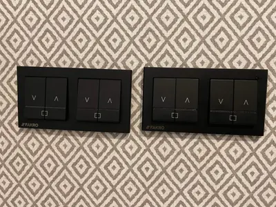 two black cabinets on a wall with a wallpaper at Main Square Platan Loft Collection in Kraków