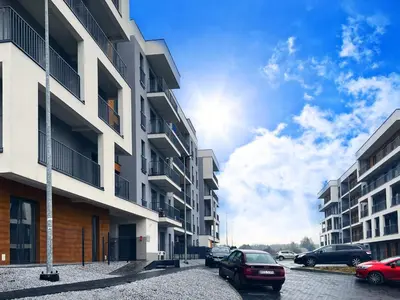 a street with cars parked in front of buildings at Prestige 12 in Zator