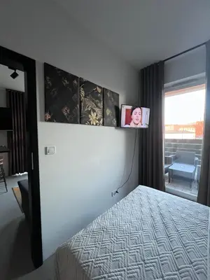 a bedroom with a bed with a picture on the wall at Prestige 12 in Zator