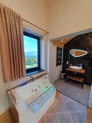 a large bathroom with a tub and a window at Tarnawa Gold, Sauna, Jacuzzi, Grota solna, in Tarnawa Dolna