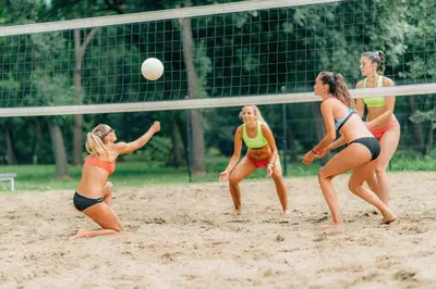 a group of women playing volleyball on a beach at Tarnawa Gold, Sauna, Jacuzzi, Grota solna, in Tarnawa Dolna