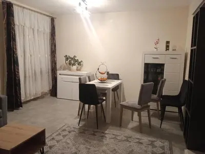 a living room with a table and chairs at Uroczy Apartament 3 in Kraków