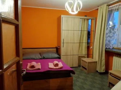 a bedroom with a bed with towels on it at Uroczy Apartament 3 in Kraków