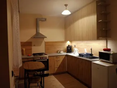 a small kitchen with a stove and a microwave at Uroczy Apartament 3 in Kraków