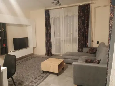 a living room with a couch and a tv at Uroczy Apartament 3 in Kraków