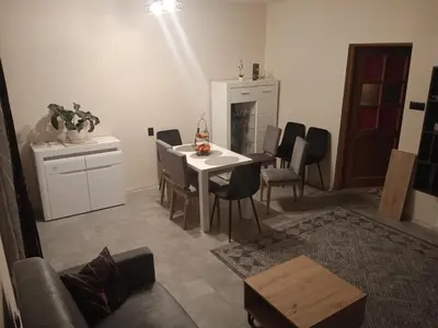 a living room with a white table and chairs at Uroczy Apartament 3 in Kraków
