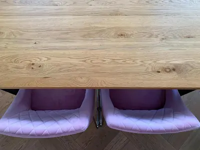 a wooden table with purple cushions under it at A modern apartment for 2 people in Kraków