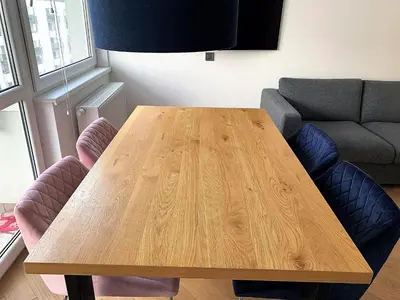 a wooden table in a living room with a couch at A modern apartment for 2 people in Kraków