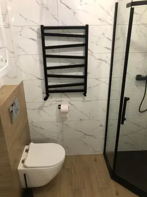 a bathroom with a white toilet and a shower at Apartament 15G in Skawina