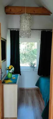 a kitchen with a vase of flowers on a counter at Mieszkanko z tarasem in Limanowa