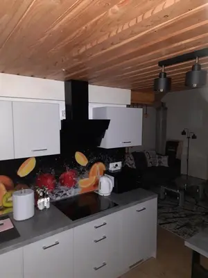 a kitchen with white cabinets and a counter top at Domek na szlaku RIKARDO in Ponice