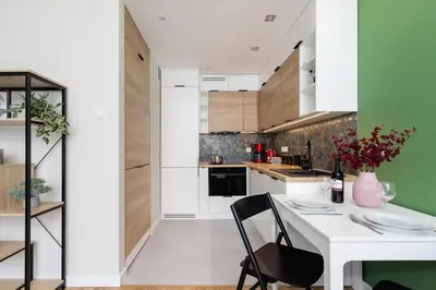 a kitchen with a white table and a black chair at Modern Apartment on Łobzowska Street by Noclegi Renters in Kraków
