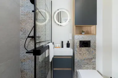 a bathroom with a sink and a mirror at Modern Apartment on Łobzowska Street by Noclegi Renters in Kraków