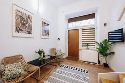 a living room with a couch and a table at NEST Cosy Apt Old Town & Wawel Hill by Vistula River - by Homelike Krakow in Kraków