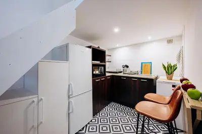 a kitchen with a white refrigerator and a counter at NEST Cosy Apt Old Town & Wawel Hill by Vistula River - by Homelike Krakow in Kraków