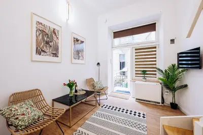 a living room with a table and chairs and a window at NEST Cosy Apt Old Town & Wawel Hill by Vistula River - by Homelike Krakow in Kraków