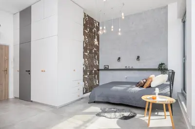 a bed with two pillows on top of it at Kraków Loft in Kraków