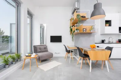 a living room with a brown chair and a table at Kraków Loft in Kraków