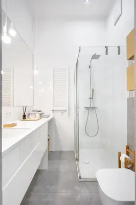 a white bathroom with a shower and a toilet at Kraków Loft in Kraków