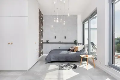 a bedroom with a bed and a large window at Kraków Loft in Kraków