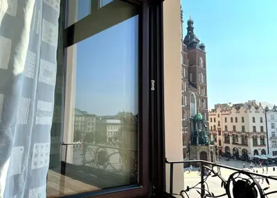 a view of a city from a window of a building at Pod Słońcem - Rynek Główny in Kraków