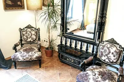 a room with two chairs and a large mirror at Pod Słońcem - Rynek Główny in Kraków