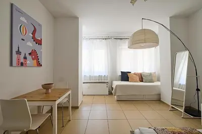 a living room with a couch and a table at Urban Nest Apartments Radziwiłłowska 12 in Kraków