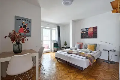 a bedroom with a bed and a desk and a table at Urban Nest Apartments Radziwiłłowska 12 in Kraków