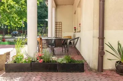 a patio with a table and chairs and flowers at Urban Nest Apartments Radziwiłłowska 12 in Kraków
