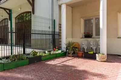 a building with a gate with plants and flowers at Urban Nest Apartments Radziwiłłowska 12 in Kraków