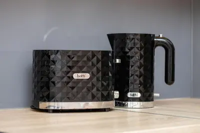 a black coffee pot sitting on top of a counter at Beautiful Apartments Kraków Dietla by Noclegi Renters in Kraków