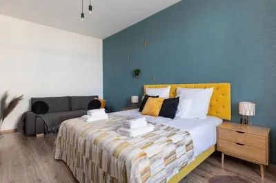 a bedroom with a large bed and a couch at Luxe Living Castle View in Kraków