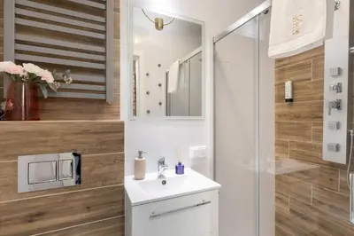 a bathroom with a sink and a shower at Luxe Living Castle View in Kraków