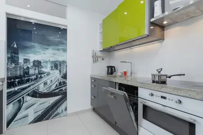 a kitchen with a view of a city at Kraków Błonia Apartment with Balcony by Noclegi Renters in Kraków