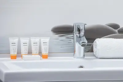 a group of test tubes sitting on a bathroom counter at Kraków Błonia Apartment with Balcony by Noclegi Renters in Kraków