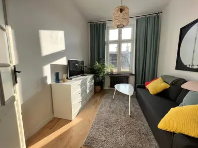 a living room with a couch and a tv at Apartment Ida, Kazimierz center in Kraków