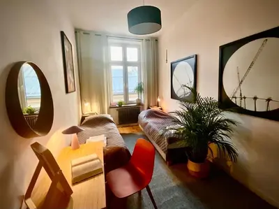 a living room with a couch and a red chair at Apartment Ida, Kazimierz center in Kraków