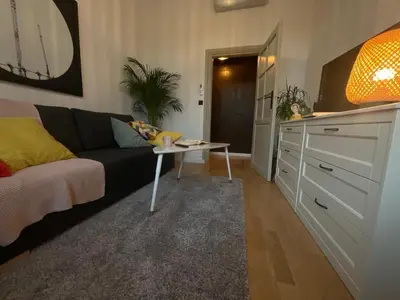 a living room with a couch and a table at Apartment Ida, Kazimierz center in Kraków