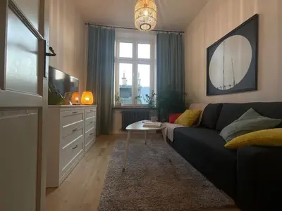 a living room with a couch and a tv at Apartment Ida, Kazimierz center in Kraków