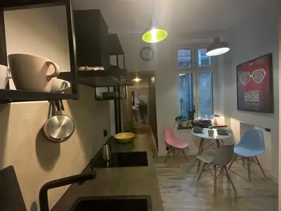a kitchen with chairs and a table in a room at Apartment Ida, Kazimierz center in Kraków