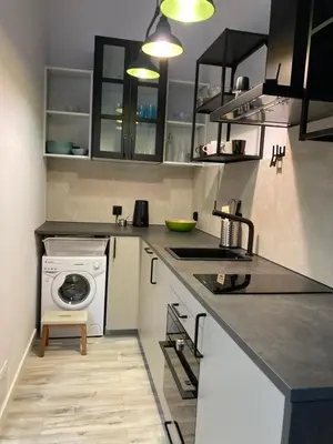 a kitchen with a washing machine and a washer at Apartment Ida, Kazimierz center in Kraków