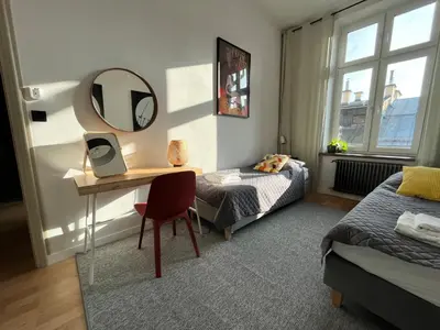 a bedroom with a desk and a bed and a mirror at Apartment Ida, Kazimierz center in Kraków