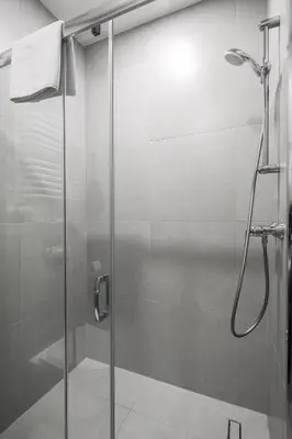 a shower with a glass door in a bathroom at Modern & cozy flat - near to Wawel Castle in Kraków