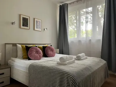 a bedroom with a bed with towels on it at Modern & cozy flat - near to Wawel Castle in Kraków