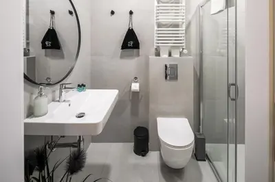 a bathroom with a sink and a toilet and a shower at Modern & cozy flat - near to Wawel Castle in Kraków