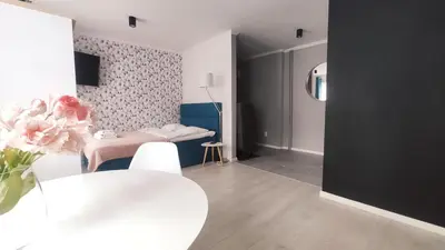 a living room with a table and a dining room at Na Szaniec 17 by Homeprime in Kraków